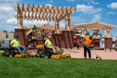 Public Works cutting grass at Eaton Town Square